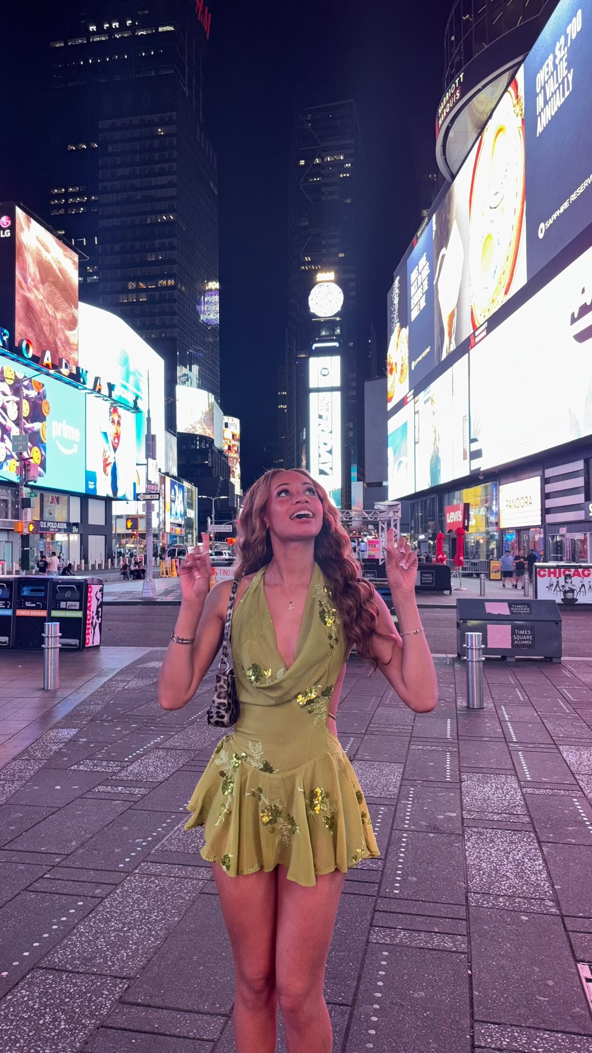 Lytoya Ri smiling beneath the lights of Times Square